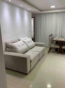 a living room with a couch and a table at Seu Refúgio em São Luís MA in São Luís