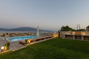 a backyard with a swimming pool and a lawn at Ciel Residence in Nafpaktos +56 photos
