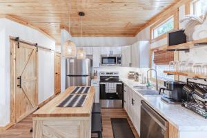 a kitchen with white cabinets and a wooden ceiling at Unit A Casa Cabana in Madison