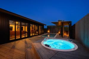 a hot tub sitting on a deck next to a house at Grand Resort Shirahama - Vacation STAY 72313v in Hongō +3 photos
