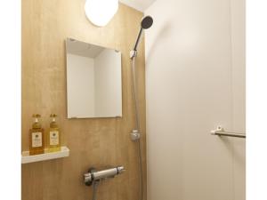 a mirror on a wall next to a shower at Smile Hotel Miyakojima - Vacation STAY 93493v in Miyako Island