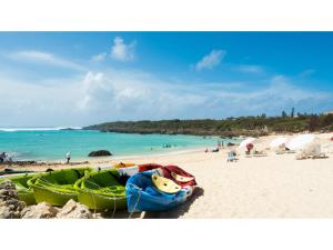 a beach with a group of boats on the sand at Smile Hotel Miyakojima - Vacation STAY 93495v in Miyako Island