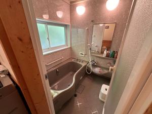 a bathroom with a bath tub and a sink at Yudensya - Vacation STAY 00050v in Kiyohashi