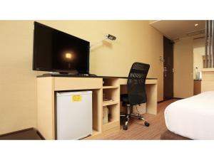 a room with a desk with a television and a chair at Smile Hotel Otsu Seta - Vacation STAY 00125v in Zeze-Awazumachi