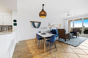 a kitchen and living room with a table and chairs at Spacious Gated Minorca Retreat, Pet Friendly with Pond Views and Resort Amenities - MM403 in Isleboro