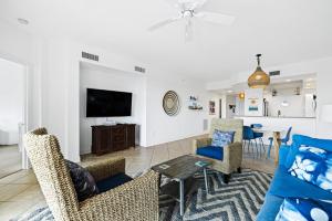 a living room with a couch and a table at Spacious Gated Minorca Retreat, Pet Friendly with Pond Views and Resort Amenities - MM403 in Isleboro