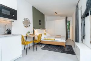 a bedroom with a bed and a table and chairs at Patrikabin in Tata