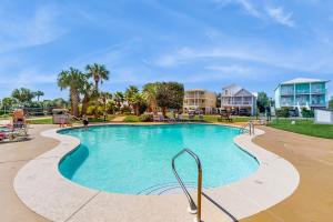 a swimming pool at a resort with people sitting around it at Plantation East #1112 in Gulf Highlands