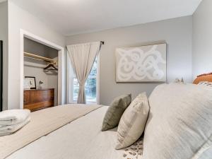 a bedroom with a large bed and a window at Modern 1BR 1BA Chic UrbanRetreat in Ames