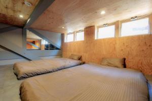 a bedroom with two beds in the middle of the room at Casa CarpeDiem - Vacation STAY 09135v in Ichinomiya +64 photos