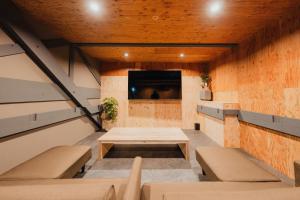 a room with a table and benches and a tv at Casa CarpeDiem - Vacation STAY 09135v in Ichinomiya