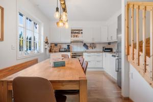 a kitchen with a wooden table and chairs in it at Fjellvangvegen 11 by Vacation Trysil in Trysil