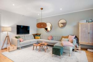 a living room with a couch and a table at Fjellvangvegen 11 by Vacation Trysil in Trysil