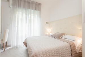 A bed or beds in a room at B&B Airone Cervia - Camere e Appartamenti