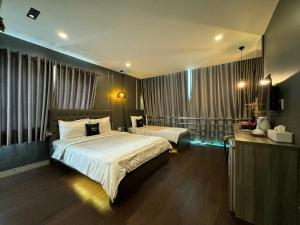 Ένα ή περισσότερα κρεβάτια σε δωμάτιο στο M&H Lux Hotel