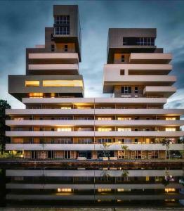 dos edificios altos junto a un cuerpo de agua en Luxury & Industrial Apartment - Amazing view, en Mulhouse