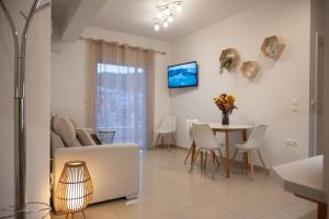 a living room with a couch and a table at Pnoé Luminous Apartment in Nafplio