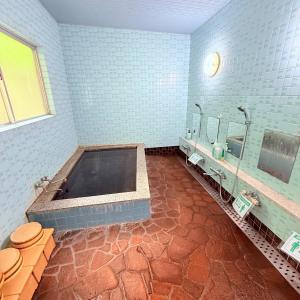 a bathroom with a tub and two sinks at Minpaku Gozamisaki - Vacation STAY 23483v in Goza +22 photos