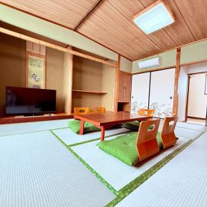 a living room with a wooden table and chairs at Minpaku Gozamisaki - Vacation STAY 23485v in Goza