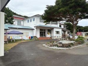 a white building with a tree in front of it at Minpaku Gozamisaki - Vacation STAY 51924v in Goza