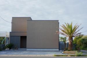 a building with a palm tree in front of it at Star-Seven Itoshima - Vacation STAY 20184 in Keya +8 photos