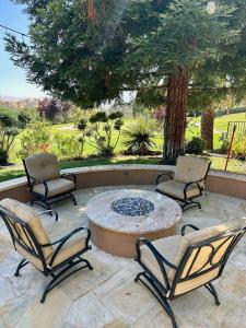 a patio with three chairs and a table and a tree at Country Club Living on Golf Course & amazing views in Pleasanton +48 photos