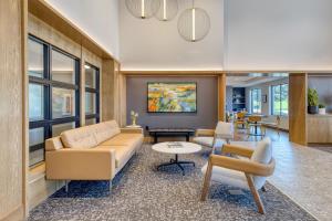 a living room with a couch and a table at Best Western Byron Center in Byron Center