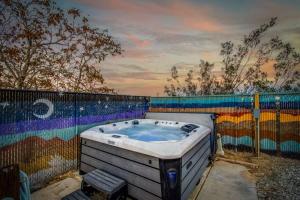 a bath tub sitting in front of a fence at Desert Haven, Pickleball, Stargazing, Spa & Views in Joshua Tree