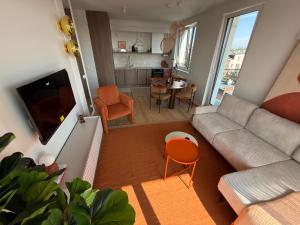 a living room with a couch and a table at 4 Seasons Apart in Tomaszów Mazowiecki