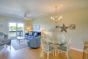 a living room with a table and chairs and a couch at Steps to Beach St Augustine Extended Stay Condo! in Coquina Gables