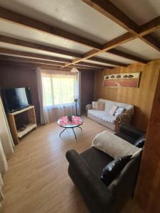a living room with a couch and a table at Cabañas el Chañar in San Pedro de Atacama