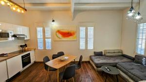 a living room with a couch and a table at Katarina in Sainte-Thérèse +10 photos