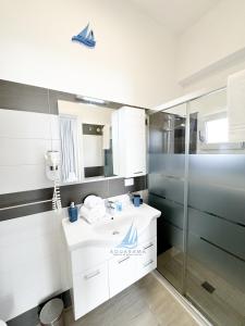 a bathroom with a white sink and a shower at AQUARAMA Rooms & Apartments in Torre Squillace