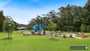 a playground with a slide in a park at Rockpool Retreat in Currarong