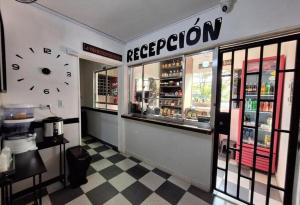a restaurant with a clock on the wall at Hotel Playa Itagui in Itagüí