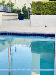 a pool of blue water next to a sidewalk at Maso palace in Polokwane