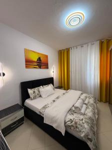 a bedroom with a large bed in a room at GES Apartment in Elbasan