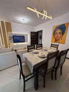 a dining room with a table and four chairs at GES Apartment in Elbasan