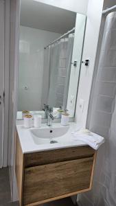 a bathroom with a sink and a mirror at let health flow in Montevideo