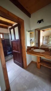 a bathroom with a sink and a large mirror at Aldea de los Cerros in Yacanto +4 photos