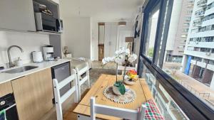 a kitchen with a table and a counter top at let health flow in Montevideo