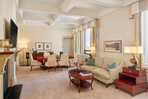 a living room with a couch and a table at Fairmont Palliser in Calgary
