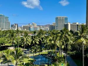 a view of a city with palm trees and a pool at Palms At Waikiki in Honolulu