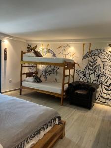 a bedroom with two bunk beds and a chair at Villa Noelia in Saboga +26 photos