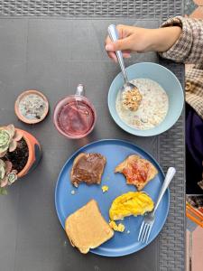 a table with two plates of breakfast food on it at Vecinos by La Palmera in Bogotá +72 photos