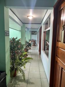 a hallway of a building with a table and chairs at Hotel FAS in Fortuna