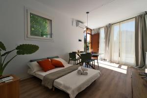 a bedroom with a bed and a table with chairs at Margherita Luxury Resort near Venice in Santo Stino di Livenza