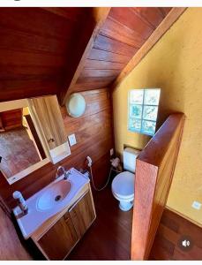 a small bathroom with a toilet and a sink at Residencial Moradas das cachoeiras 10 minutos da Praia Guarda Do Embaú SC in Palhoça +32 photos