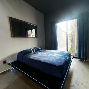 a bedroom with a bed with a mirror and a window at Casa con alberca en Morelos in Barranca Honda +13 photos