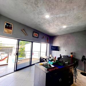 a kitchen with a sink and a counter in a room at Casa con alberca en Morelos in Barranca Honda